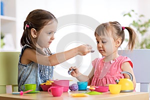 Kids playing with plastic tableware