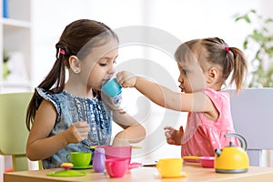 Kids playing with plastic tableware