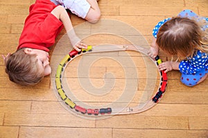 Kids playing with railroad and trains indoor