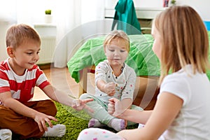 Kids playing rock-paper-scissors game at home