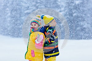 Kids playing in snow. Children play in winter.