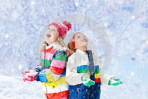 Kids playing in snow. Children play in winter.