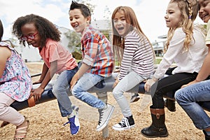 Kids playing on a spinning carousel in their schoolyard