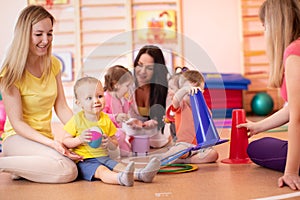 Kids playing with sport equipment in nursery gym