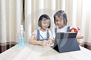 Kids playing and stay at home, children funny and joyful learn online in tablet on table,