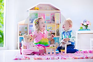 Kids playing with stuffed animals and doll house