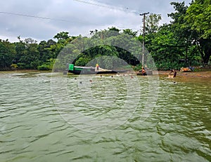 Kids playing and swimming in the river water during the rainy season of Bangladesh