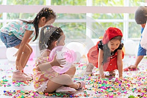 Kids playing and throwing paper and balloon in kid party