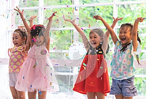 Kids playing and throwing paper in kid party