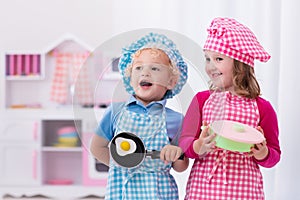 Kids playing with toy kitchen