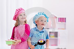 Kids playing with toy kitchen