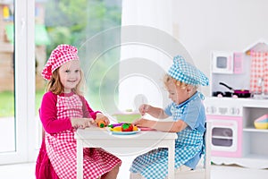 Kids playing with toy kitchen