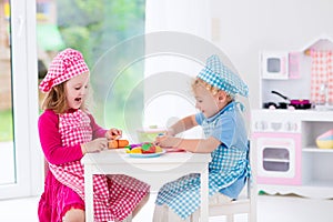 Kids playing with toy kitchen