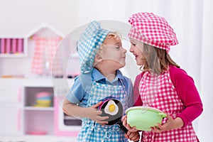 Kids playing with toy kitchen