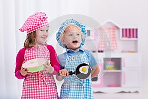 Kids playing with toy kitchen