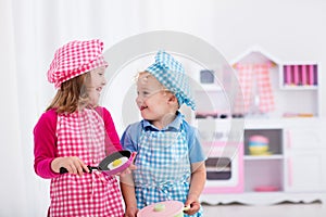 Kids playing with toy kitchen