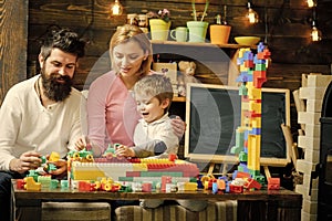 Kids playing with toys. Lovely family in playroom. Mom and kid playing with cars on race track out of plastic blocks