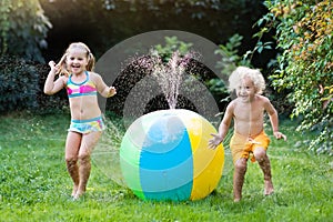 Kids playing with water ball toy sprinkler