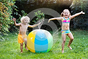 Kids playing with water ball toy sprinkler