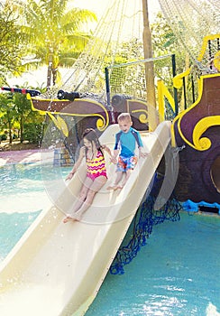 Kids playing on a water slide at a waterpark