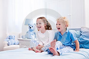 Kids playing in white bedroom