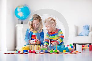 Kids playing with wooden toy train