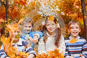 Kids playing with yellow leaves