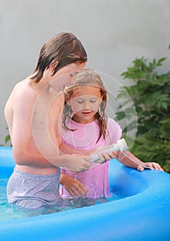 Kids in pool measuring temperature