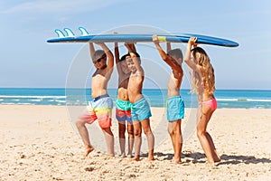 Kids portrait carry surfboard on the beach