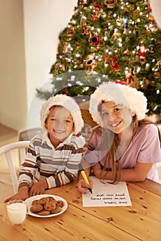 Kids, portrait and christmas cookies note for festive celebration with young siblings in home. Happy, children and
