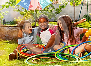 Kids portrait with hula hoops together on grass