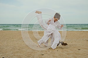 Kids practicing Aikido on the beach