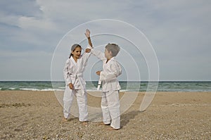 Kids practicing Aikido on the beach