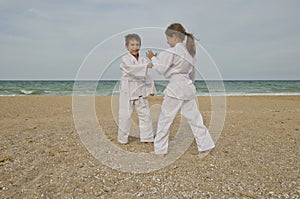 Kids practicing Aikido on the beach