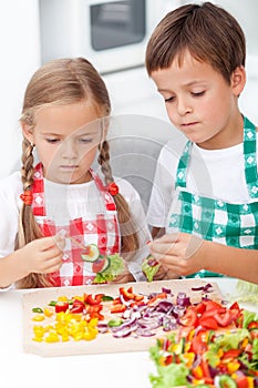 Kids preparing veggies on stick photo