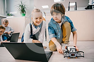 kids programming robot on floor