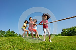 Kids pull rope - a competitive fun game in park