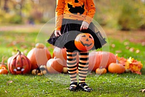 Kids with pumpkins in Halloween costumes