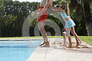 Kids Pushing Father Into Swimming Pool