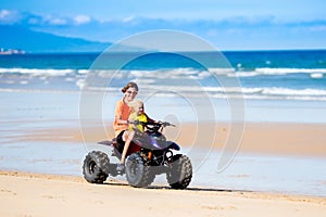 Kids on quad bike. Off road all terrain vehicle.