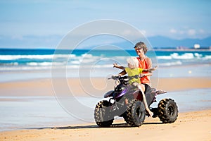 Kids on quad bike. Off road all terrain vehicle.