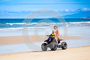 Kids on quad bike. Off road all terrain vehicle.