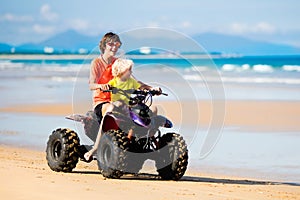 Kids on quad bike. Off road all terrain vehicle.