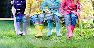 Kids in rain boots. Foot wear for children.