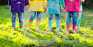 Kids in rain boots. Foot wear for children.