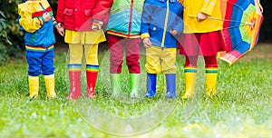 Kids in rain boots. Rubber boots for children.