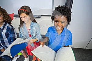 Kids reading book in classroom