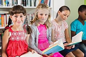 Kids reading a book in library