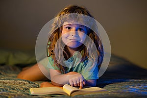 Kids reading story. Child reading a book in bed before going to sleep. Child reading a book on bedtime night. Boy