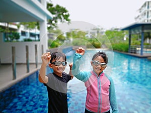 Kids ready for swimming at the swimming pool.